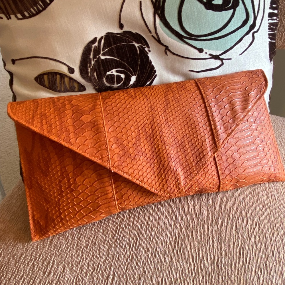 Orange snake skin clutch